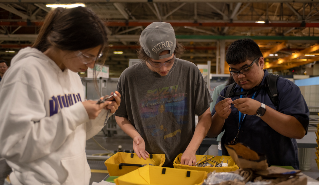 Students working on a hands-on project in a factory