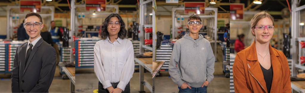 A photo of four students inside of factory. 