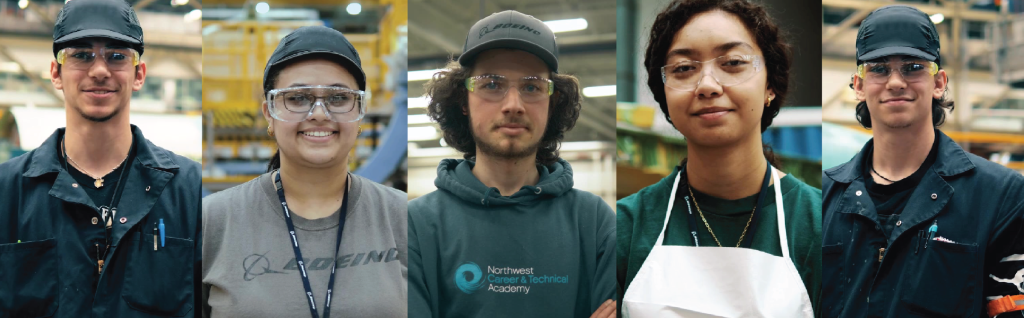 four people inside of a factory. Each person is wearing eye protection.